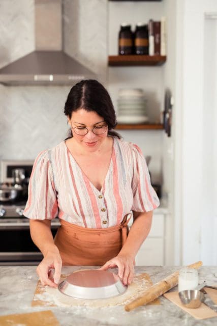 Joy the Baker measuring out pie crust with a pan.