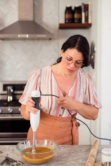 Joy the Baker emulsifying sweet potato pie filling with an immersion blender.