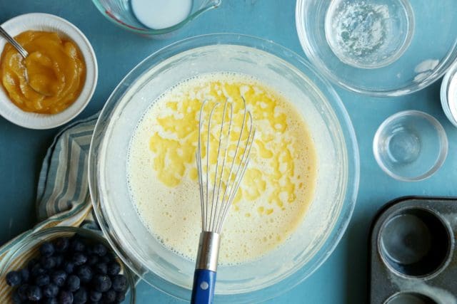 Melted butter mixed into popover batter in a bowl.