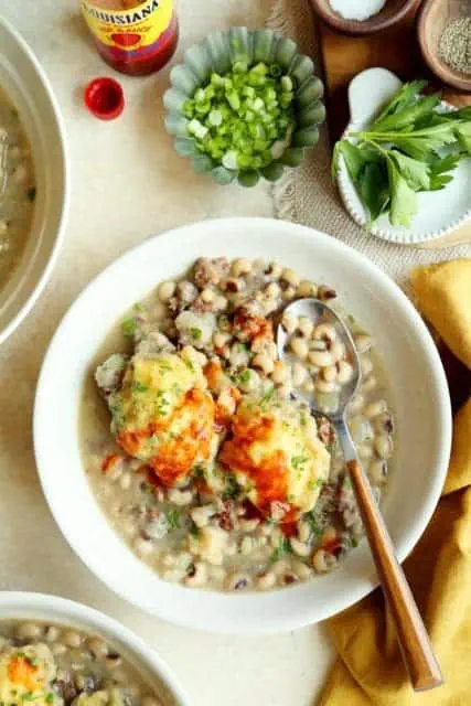 Bowl of black eyed pea stew with cornbread dumplings.