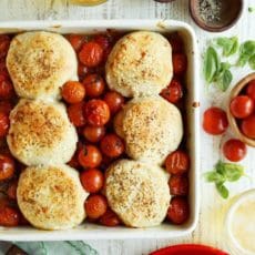 Tomato pie baked in a squarer dish with golden brown biscuits