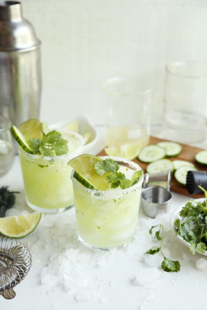 Fresh lime and cilantro garnishing a margarita.