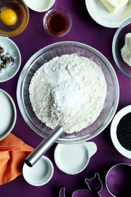 Dry ingredients for Halloween sugar cookie recipe in a glass bowl.
