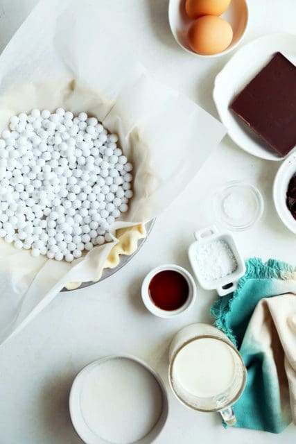 Parchment paper and pie weights in crust.
