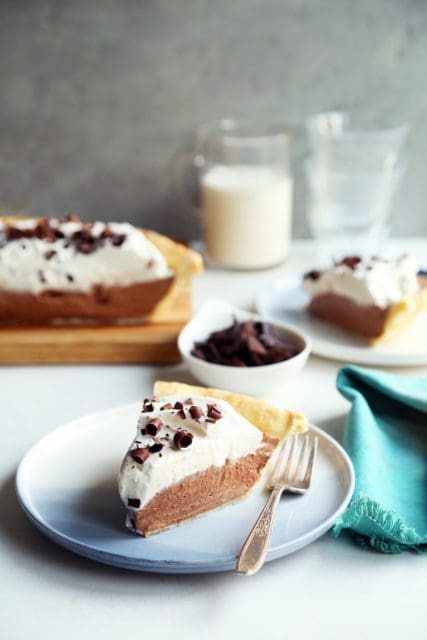 Slice of french silk pie on small blue plate.