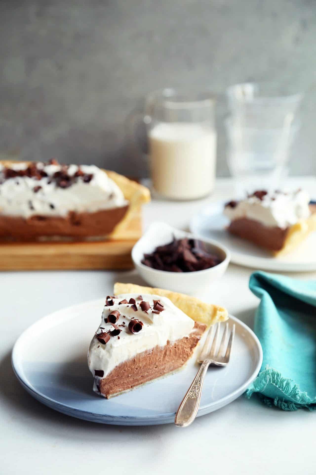 Slice of french silk pie on small blue plate.
