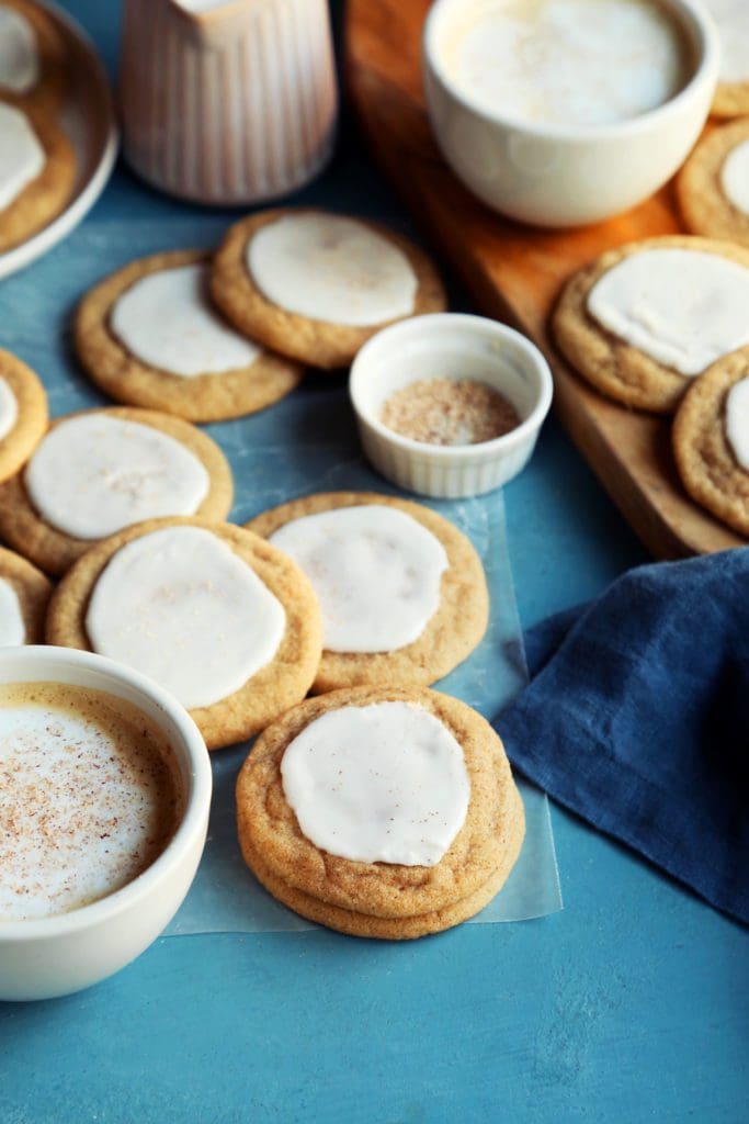 Taylor Swift cookie recipe glazed and stacked on a blue board.