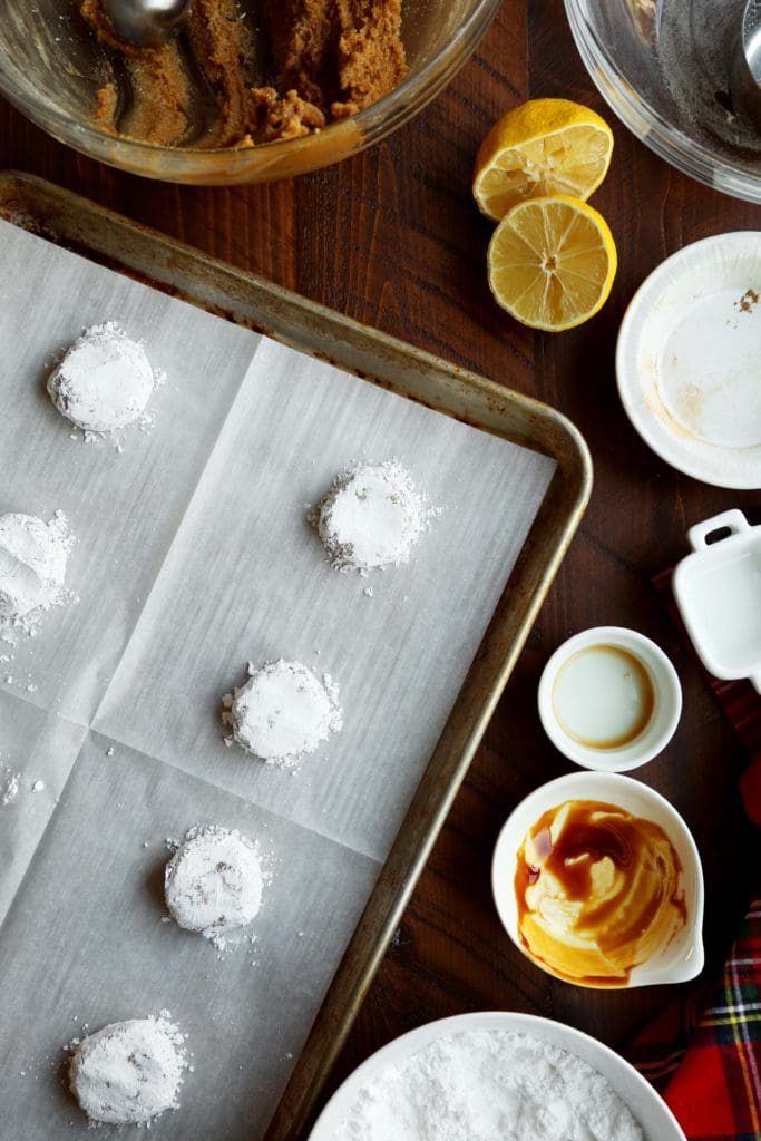 Gingerbread riciarelli cookie dough covered in powdered sugar on a baking pan
