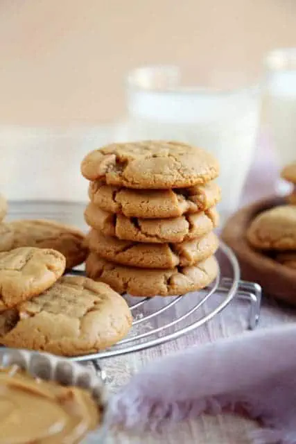 Crisp, salty, sweet peanut butter cookie recipe stacked on rack,