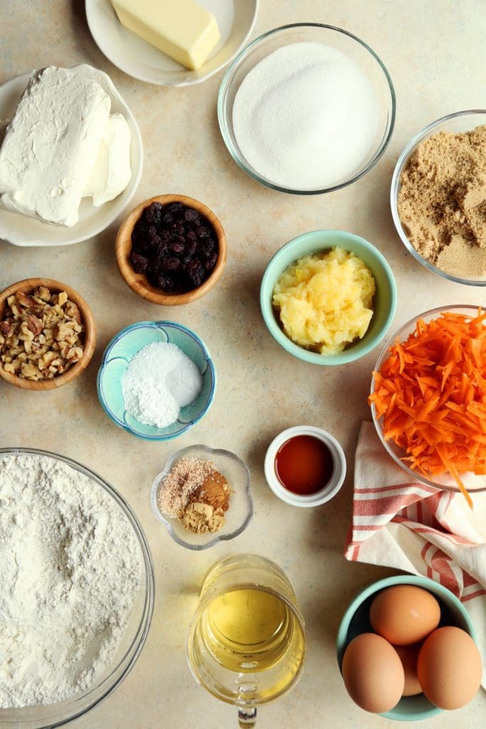 Ingredients for carrot cake recipe in small bowls for baking.