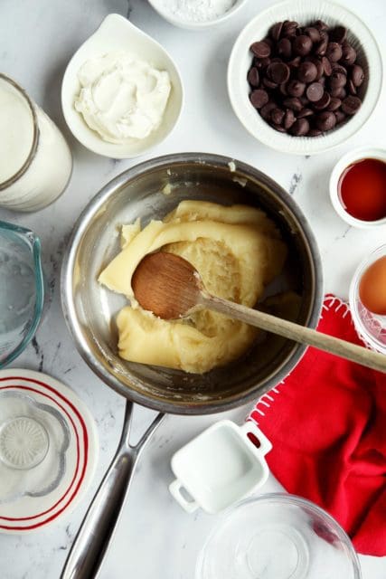 Eclair batter in pot to cool.