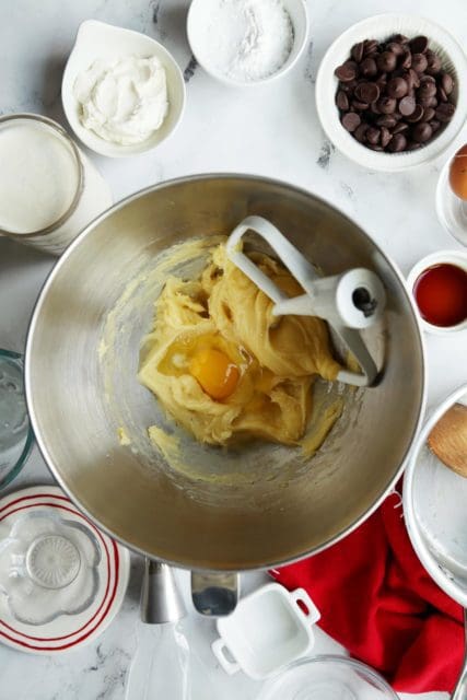 Egg added to choux batter for eclair recipe.