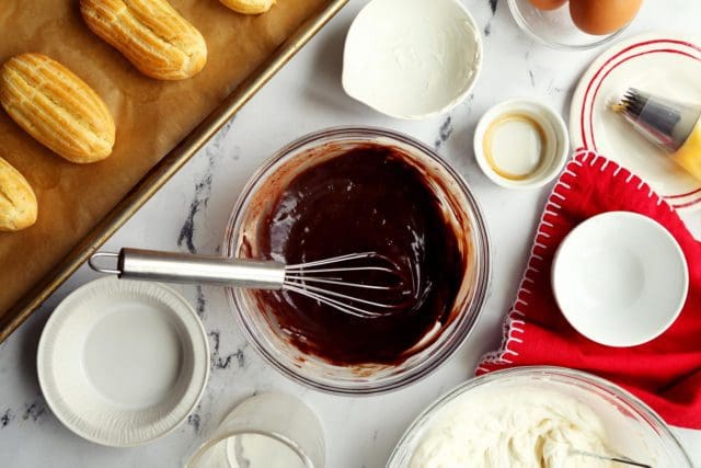 Whisked chocolate ganache in small bowl with whisk