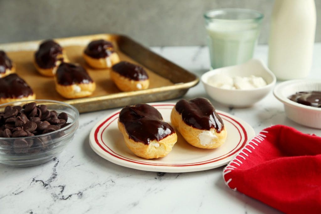 Two small eclairs on a plate.