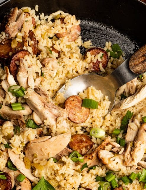 Serving finished jambalaya recipe into bowls.