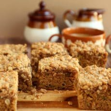 Coffee cake recipe cut into squares on a wooden board.