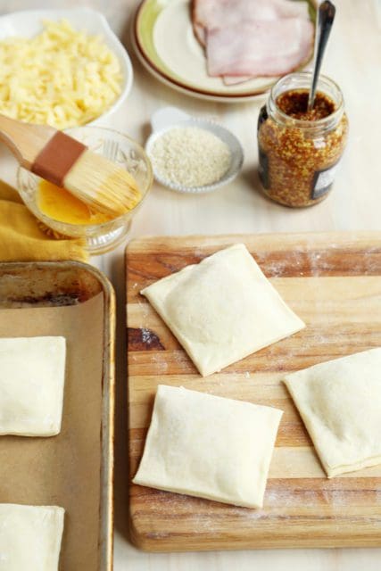 Ham and cheese croissants cut into squares.