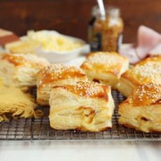 Layers of baked puff pastry on wire rack.