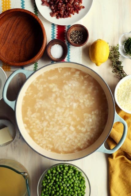 Adding chicken stock to easy risotto recipe.