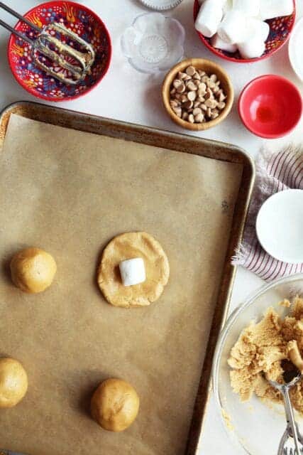 Small disk of peanut butter cookie dough with marshmallow in center