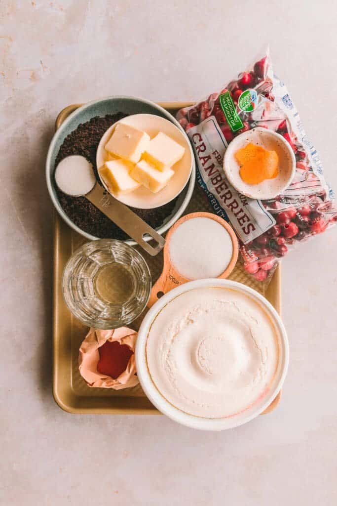 Ingredients for creamy cranberry pie measure out on baking sheet