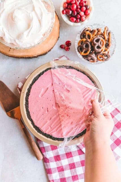 Removing plastic wrap from chilled pie.