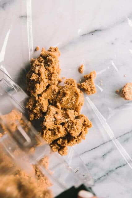 Combining cookie dough on plastic wrap.