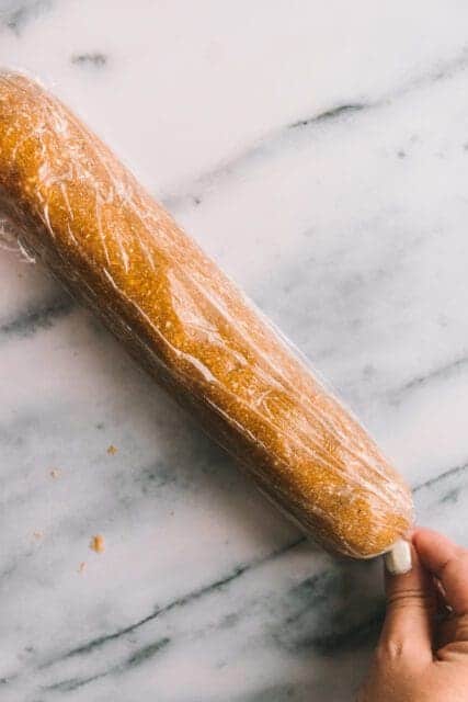 Rolling cookie dough into log in plastic wrap.