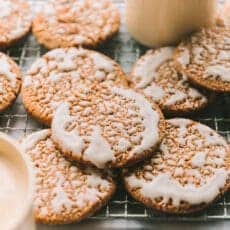 Iced Oatmeal Cookies layered on a cooling rack.