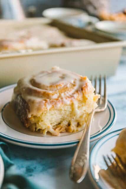 Orange roll on a plate with a fork.