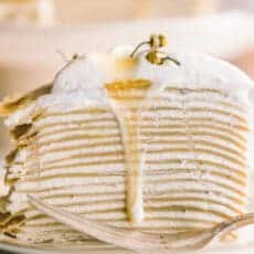 photo of the layers of crepes and cream with honey dripping down the side