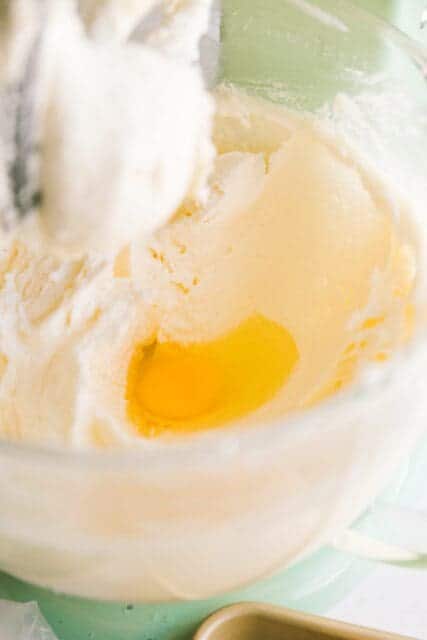 adding eggs into 4th of July cake recipe