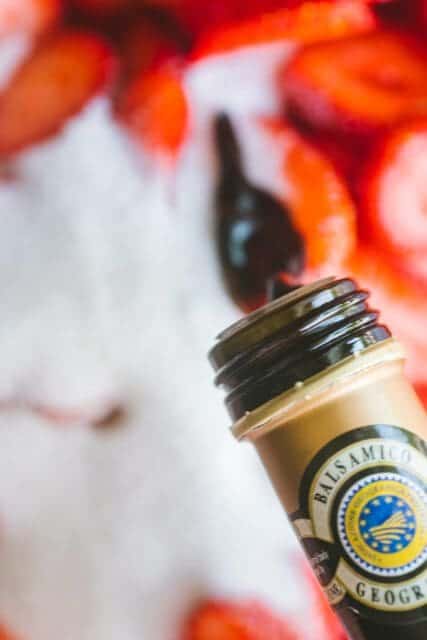 adding liquid to sugar and strawberries