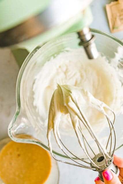 whipping heavy cream into stiff peaks to fold in
