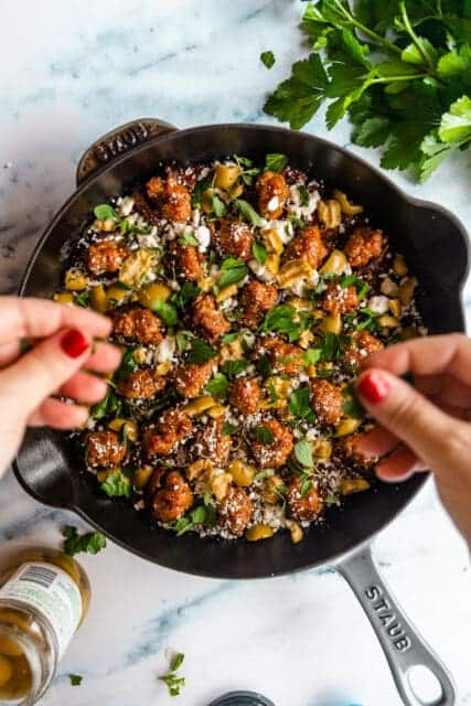 generously sprinkling stuffed dates with herbs