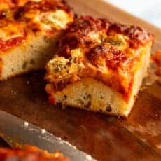 slice of doughy pizza with a crispy crust