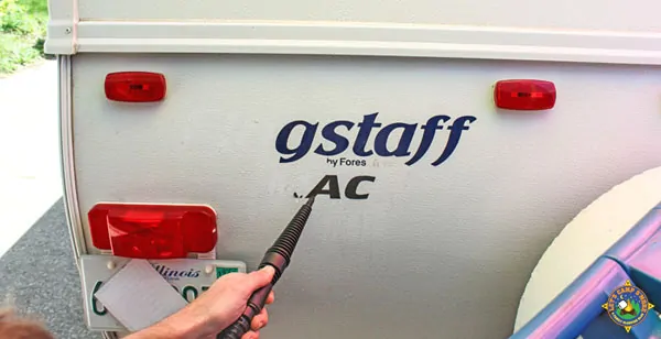 decal being removed from the back of an RV