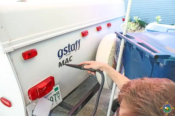 decal being removed from the back of an RV