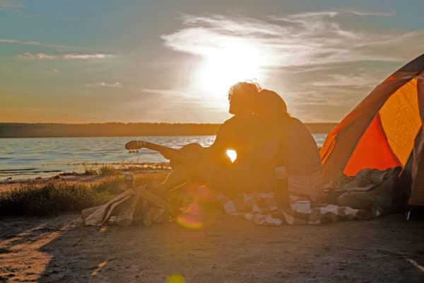 romantic couple camping with a tent