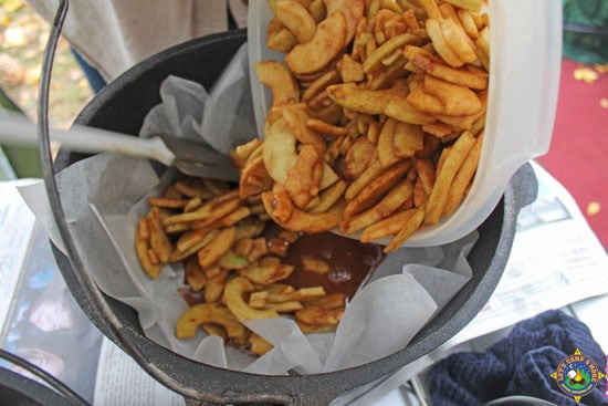 sliced apple mixture being added to a Dutch oven