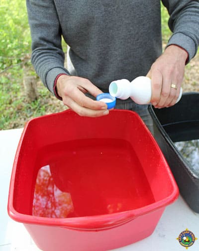 man measuring a capful of bleach