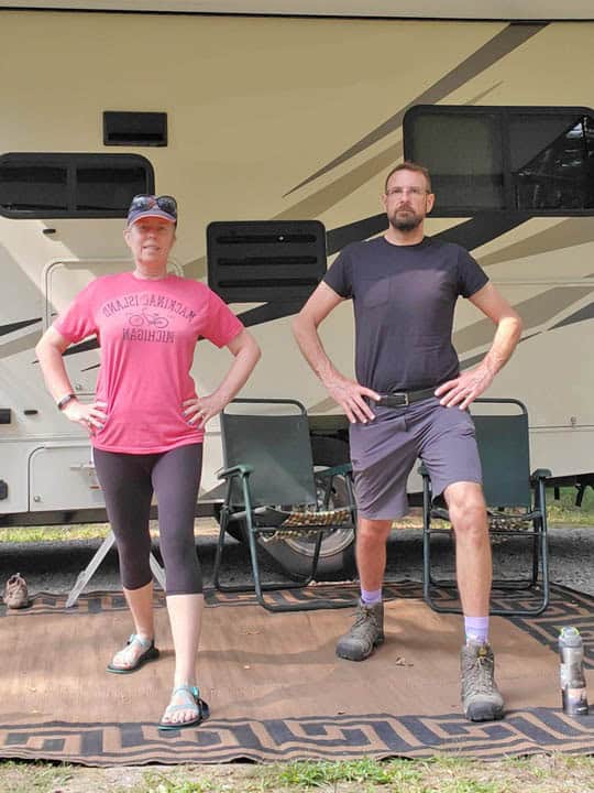 couple exercising outside of a motorhome