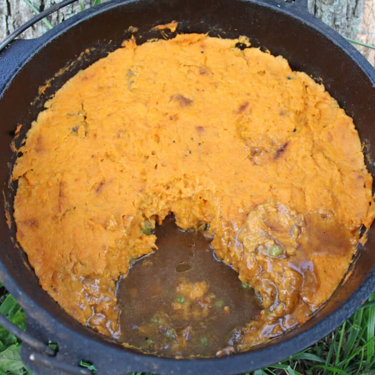 zoomed photo of baked shepherds pie in a cast iron pot