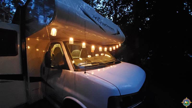 decorative lights hanging across the front of a motorhome and reflecting in the windshield