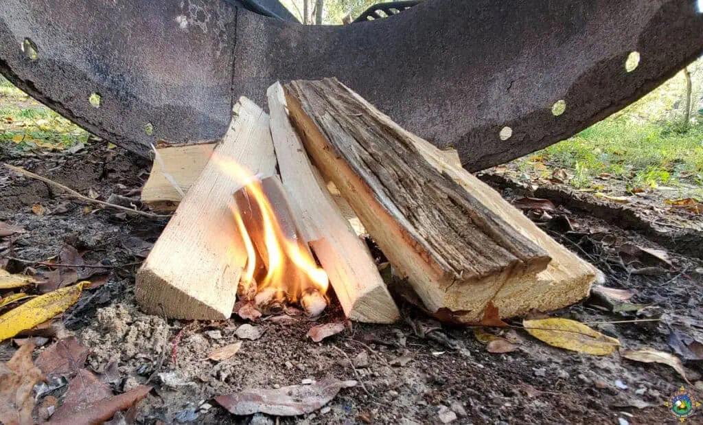 a fire starter on fire in a fire ring at a campground