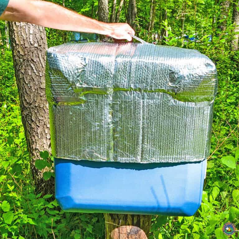 man pulling a cover off an ice chest