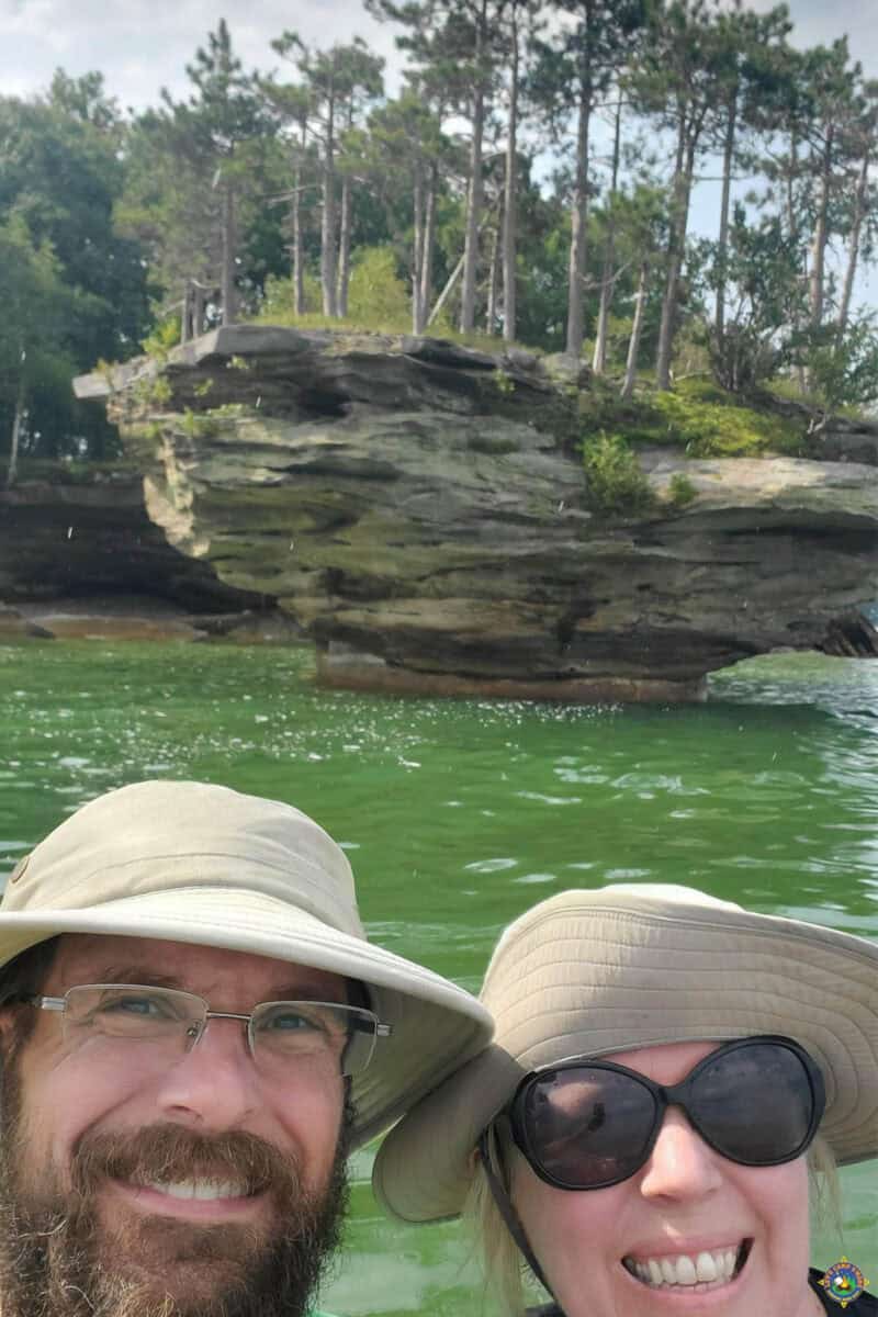 selfie of a couple on a boat with Turnip Rock in the background