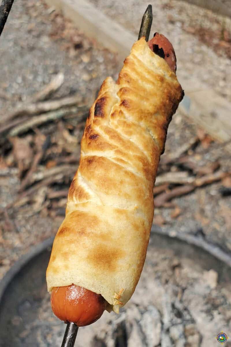 a Pig in a Blanket hot dog at the campfire