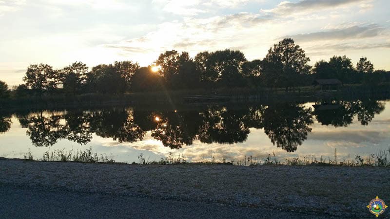 trees reflecting in a pond at sunset in the prairie in Illinois