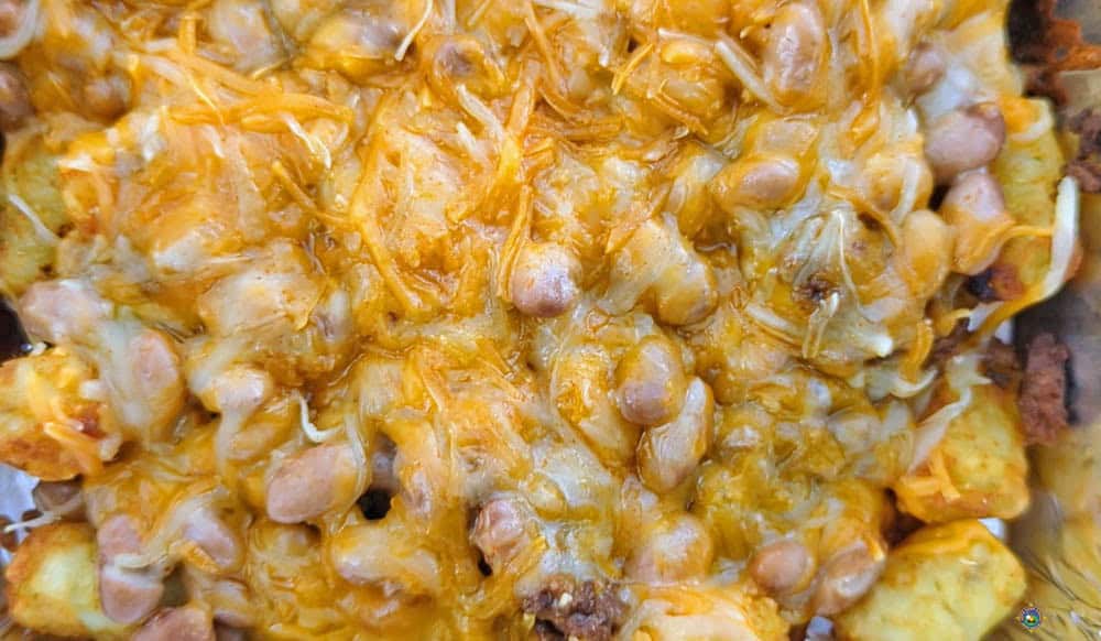 close up of cheese tots with beans and meat